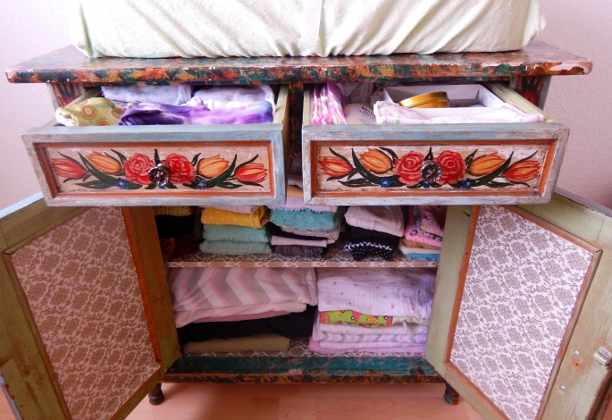 Dresser/changing table with all clothes and blankets washed line dried and ready to go.